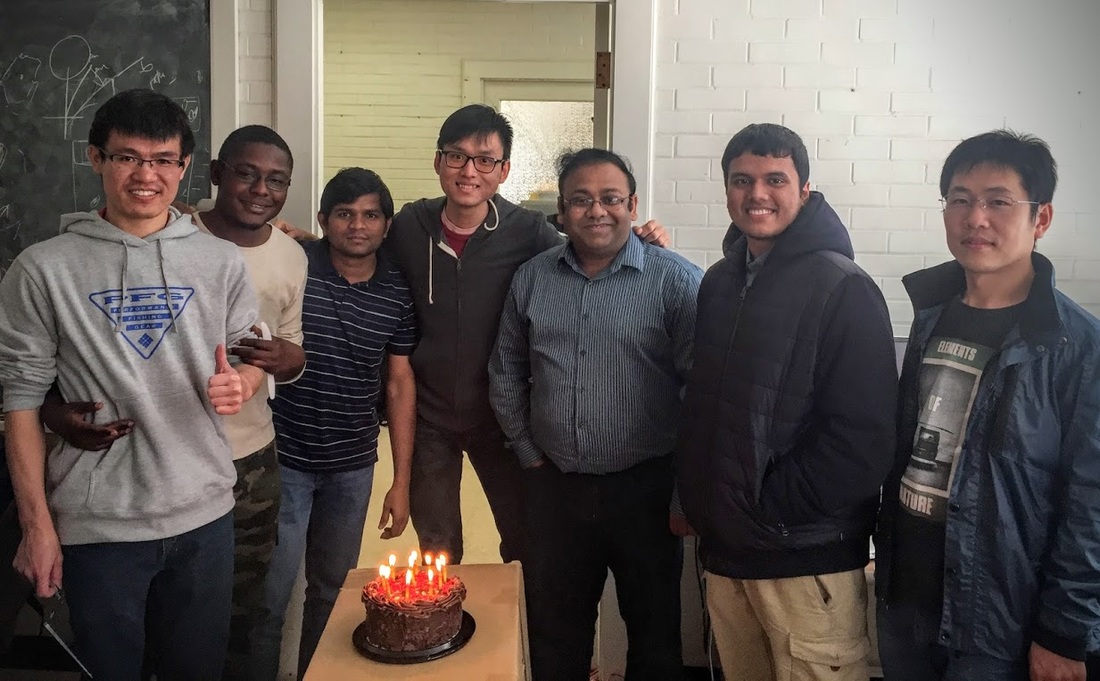Lab members celebrating with a cake (home page section background)