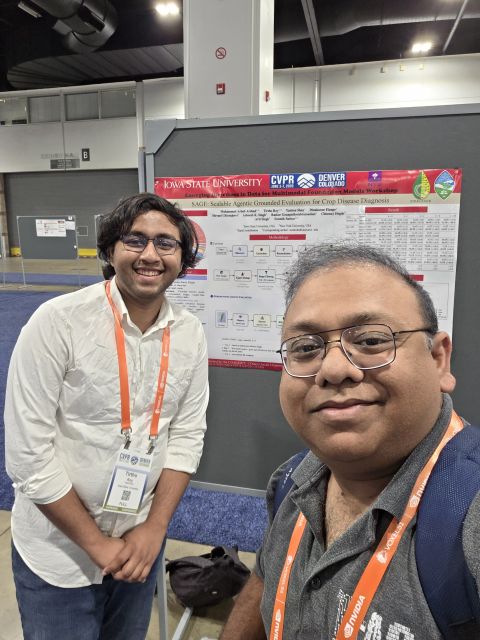 Two smiling men wearing conference badges in front of an Iowa State University research poster at CVPR.