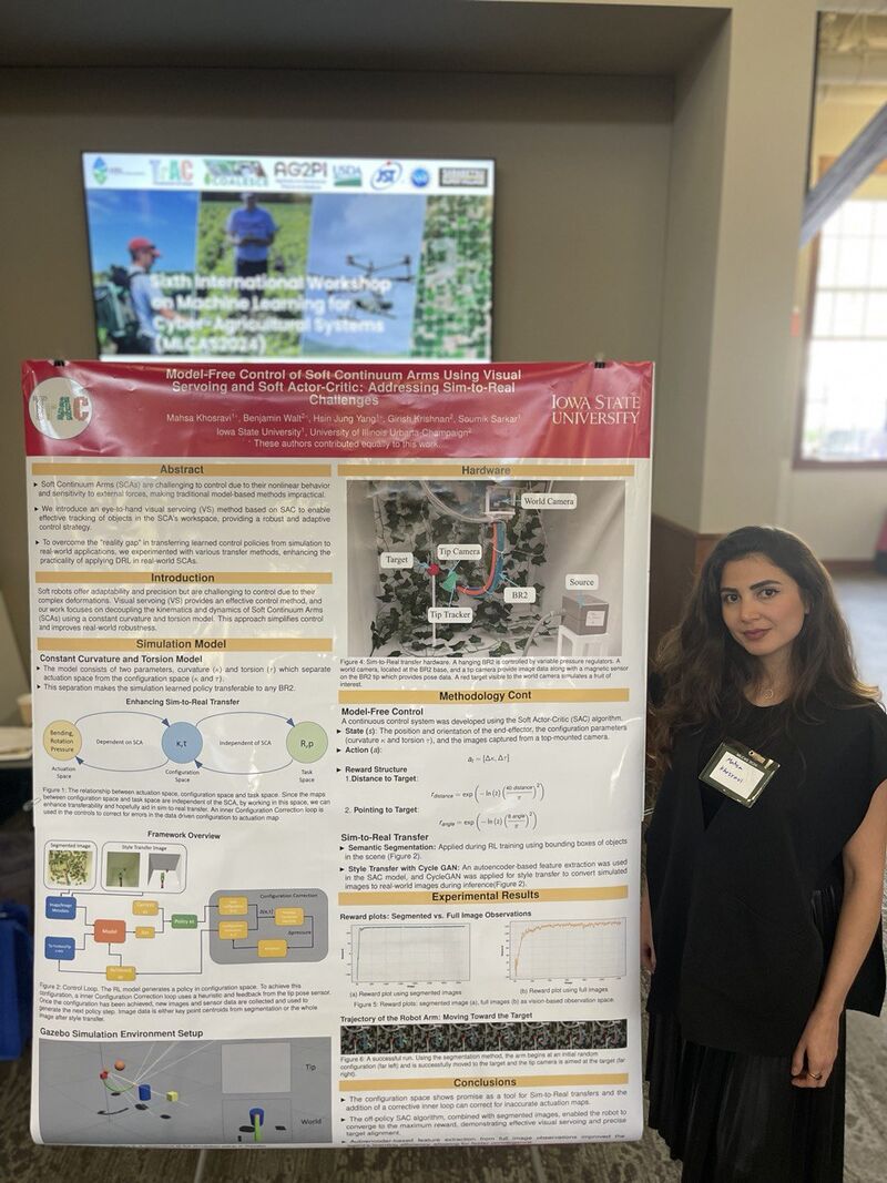 A researcher standing beside a poster on soft continuum arm control, with an MLCAS workshop screen in the background.