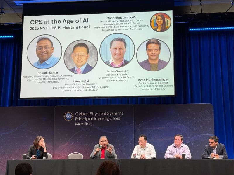 Five panelists at a table on stage beneath a projected slide showing their portraits and the title "CPS in the Age of AI".